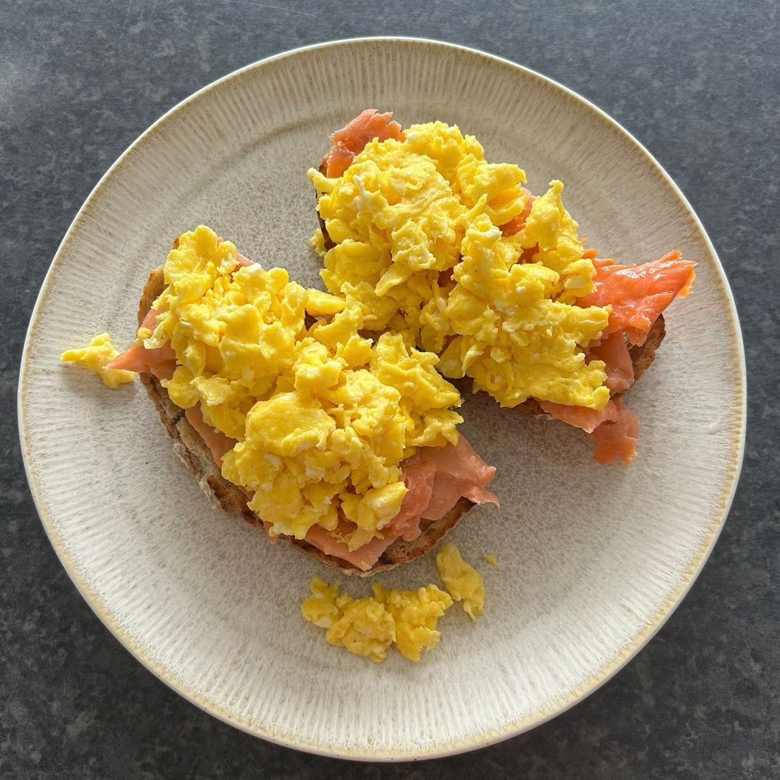 Creamy soft scrambled eggs with ribbons of smoked trout, lemon zest and fresh herbs served on toasted sourdough.