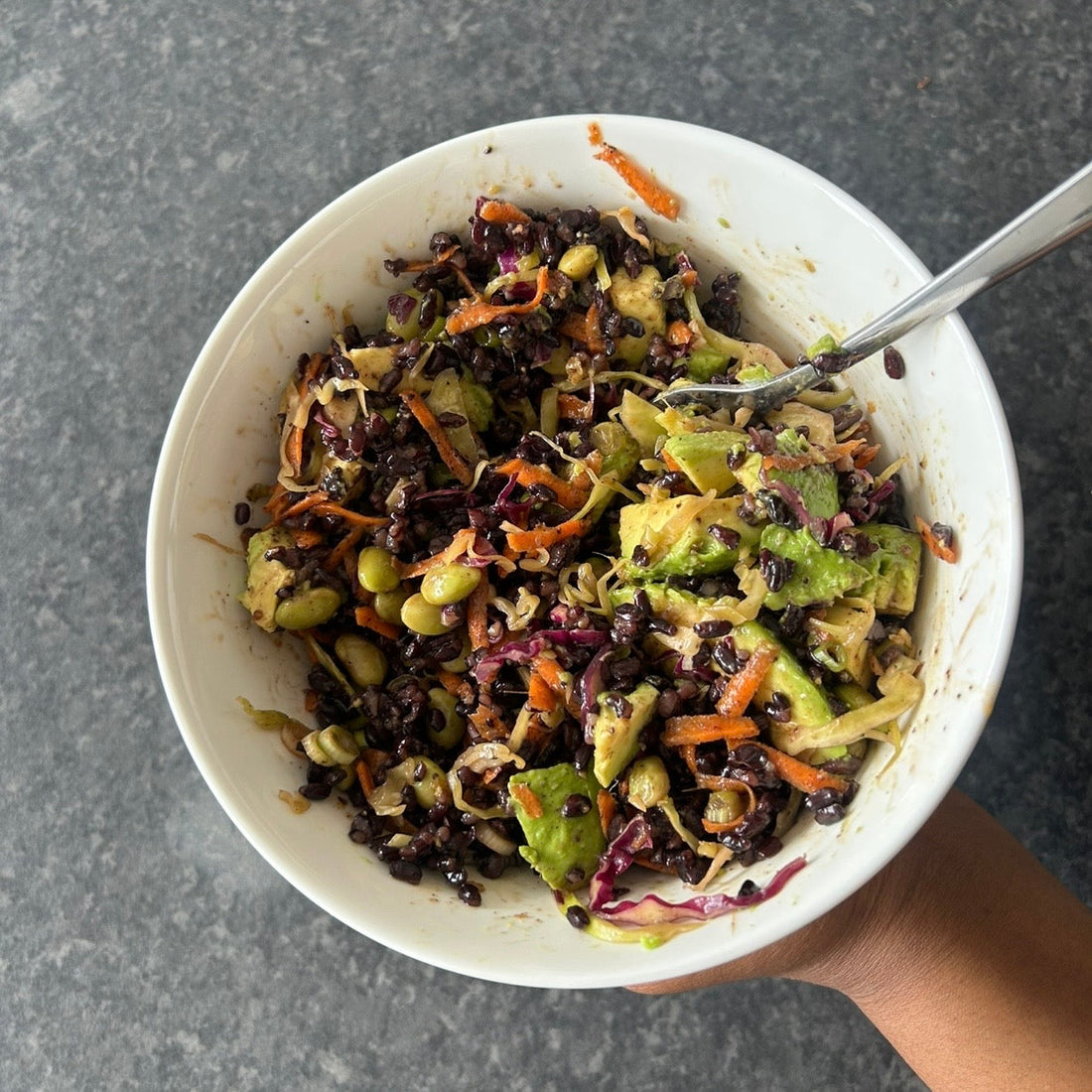 Black rice slaw salad with edamame, cabbage and carrots in a soy ginger dressing.