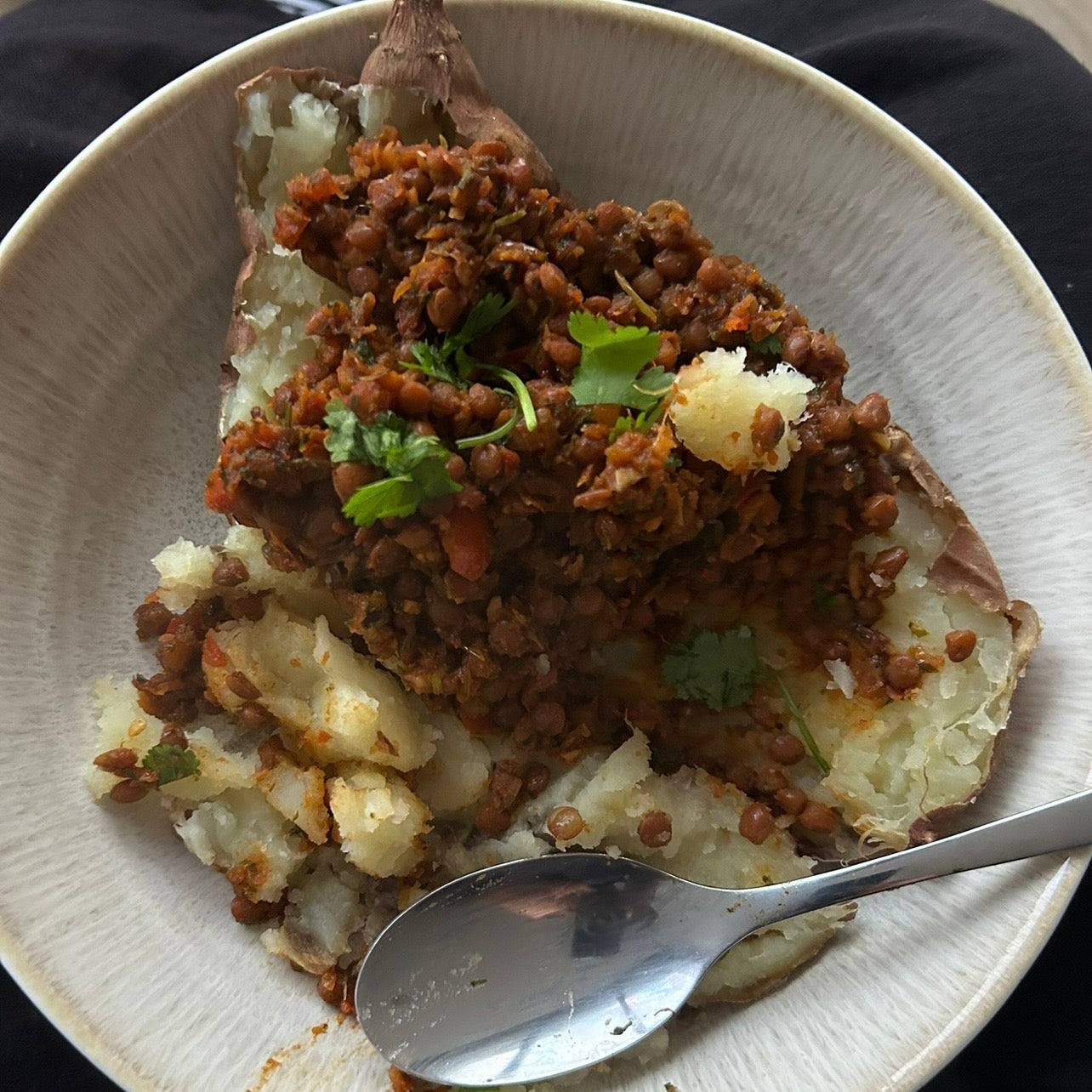 Smoky lentil and vegetable stir fry served over roasted sweet potato.
